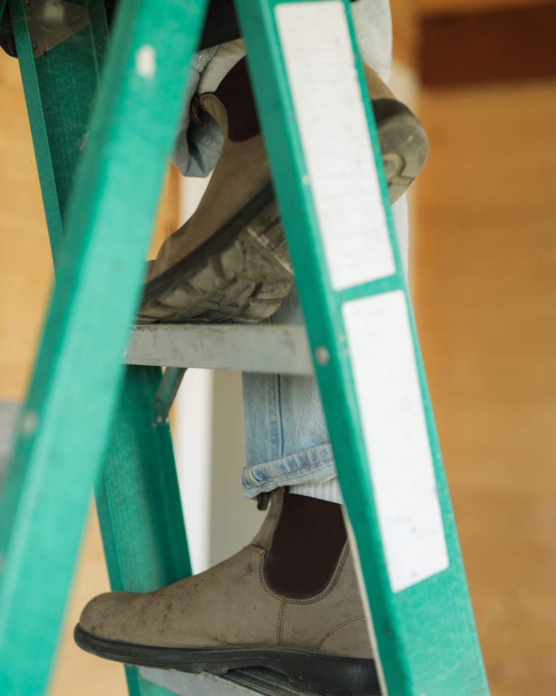 Work boots on the rungs of a step ladder on site