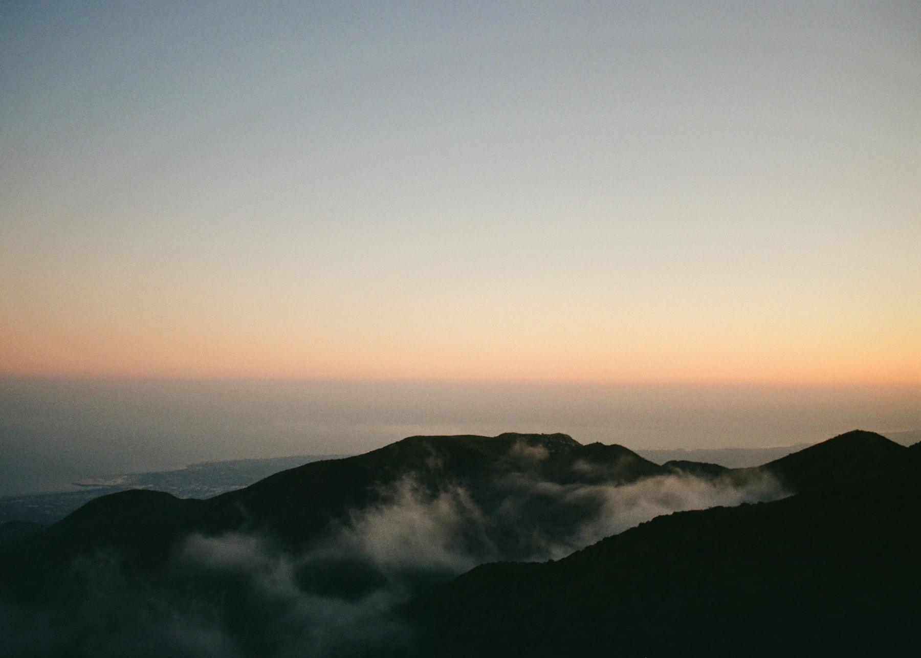 Fog moving through the coastal mountains at dusk